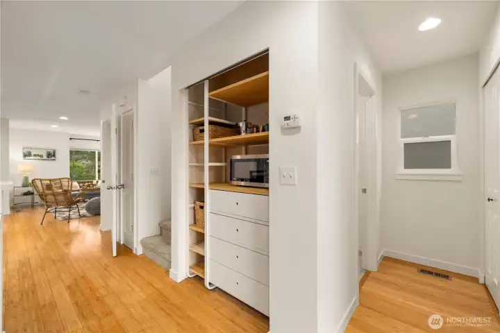 Additional kitchen storage and microwave opposite the breakfast bar.