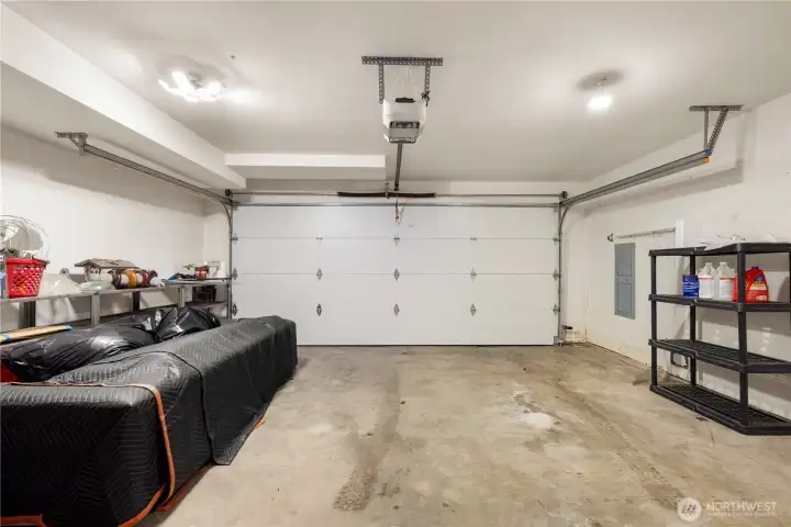 Two car garage has a brand new insulated garage door.