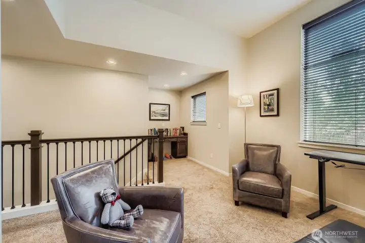 loft area open to work space with desk.