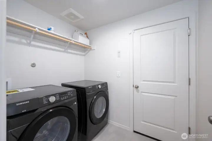Utility + laundry room connecting to garage.
