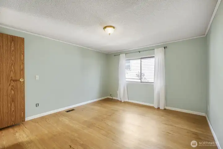 Spacious primary bedroom with peaceful tones and plenty of room to unwind.