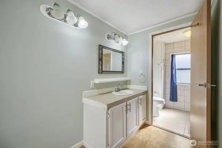 Private primary bath with generous counter space and convenient layout.