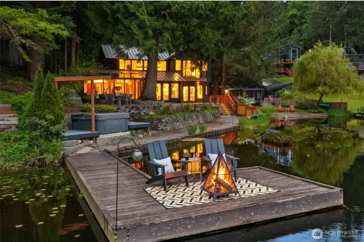 Private dock and hot tub with seating area.