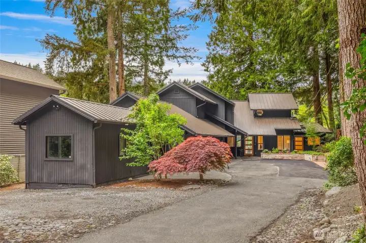 3 car garage plus an outbuilding with power and tons of extra parking!