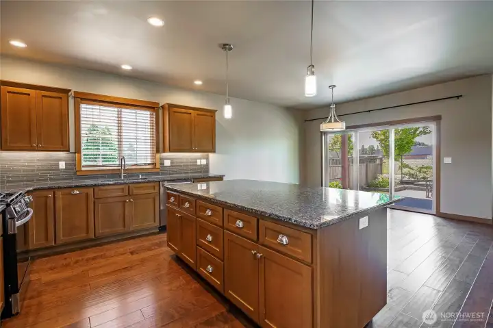 Kitchen features stainless appliances and large island with eating bar. Kitchen features stainless appliances and large island with eating bar.