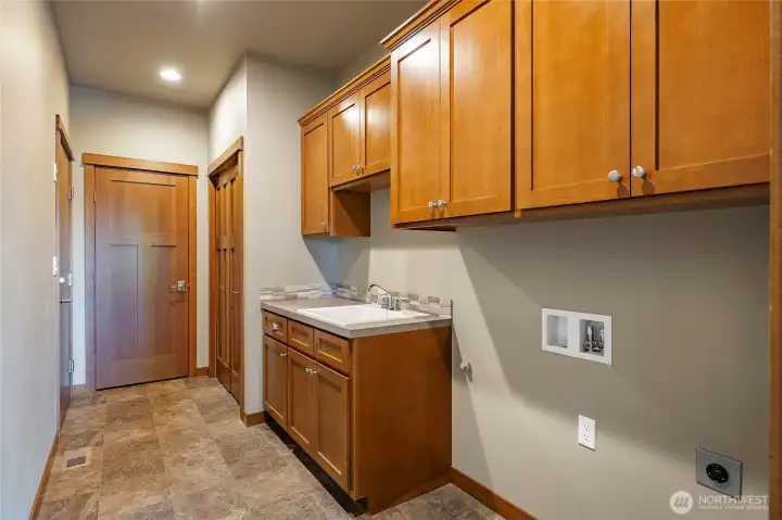 Main floor laundry room with extra storage closets and opens into garage. Main floor laundry room with extra storage closets and opens into garage.