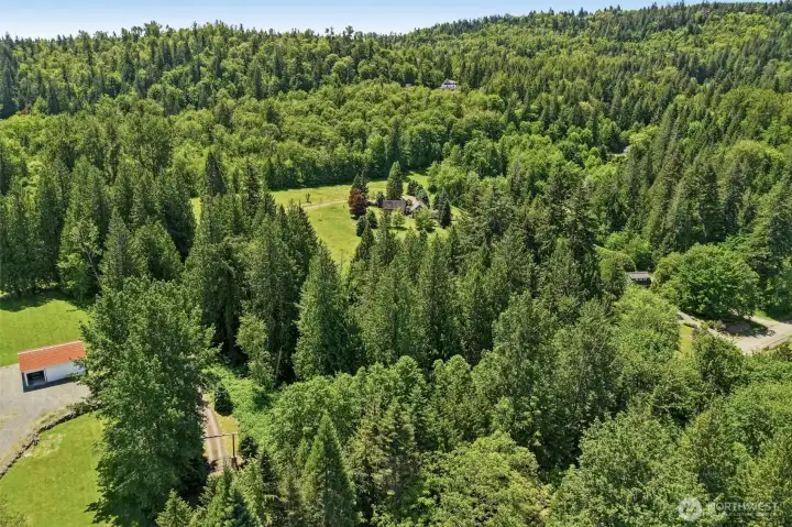 Expansive lawns, mature forests, and a second 4.57-acre parcel combine to create nearly 10 acres of opportunity, privacy, and Pacific Northwest beauty."