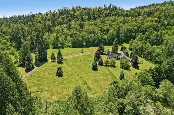 Beautifully cleared acreage offers a rare combination of privacy, usability, and breathtaking Pacific Northwest scenery.