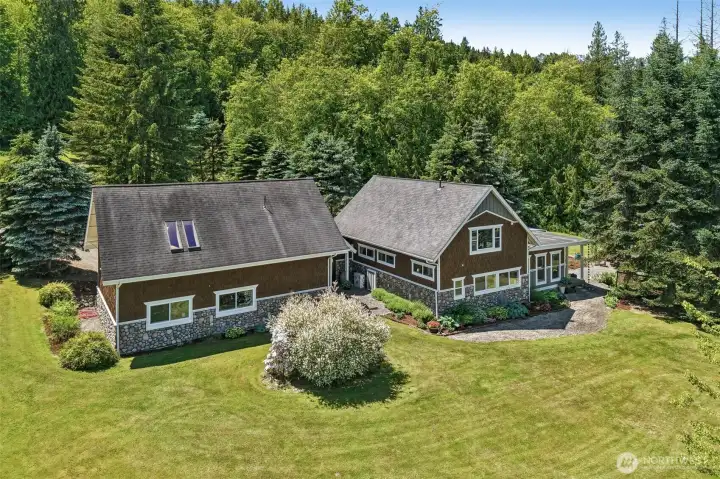 Aerial view highlights the thoughtfully expanded home, oversized three-car garage.