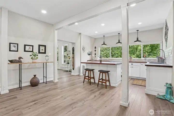 The open-concept floor plan creates a seamless flow between the living room, dining area, and kitchen, making everyday living and entertaining effortless.