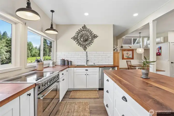 Thoughtfully designed for everyday living, this inviting kitchen offers generous workspace, ample storage, and views of the surrounding landscape.