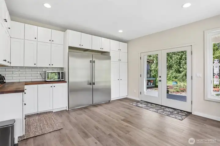 Floor-to-ceiling cabinetry provides exceptional storage while French doors invite natural light and views of the surrounding grounds.