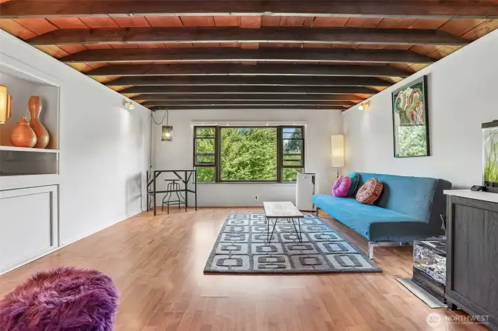 Enjoy comfort and flexibility in this oversized bedroom featuring natural light, open space, and views of the surrounding landscape.