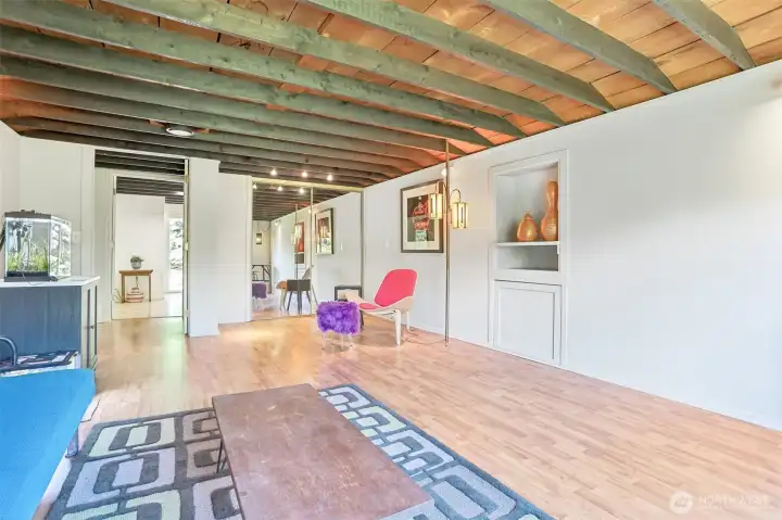 Warm wood-beam accents and expansive square footage create a comfortable bedroom retreat filled with character and charm.