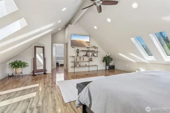 Enjoy the comfort of this oversized primary suite showcasing vaulted ceilings, skylights, and abundant room to unwind at the end of the day.