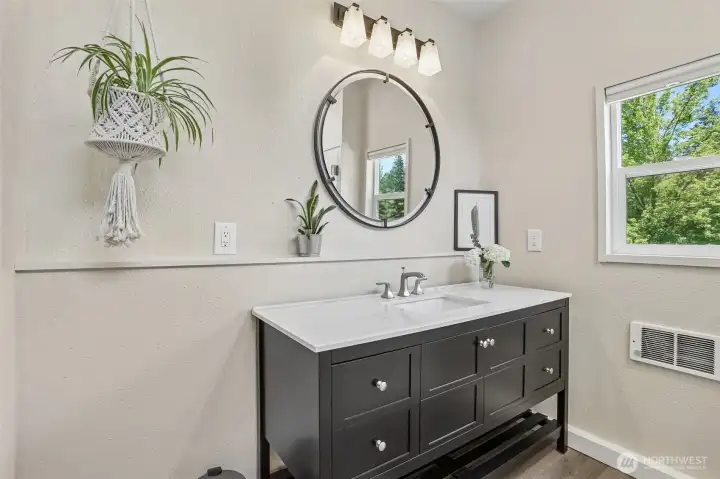 Beautifully refreshed, the guest 3/4 bathroom offers modern updates and easy access from the main living areas.