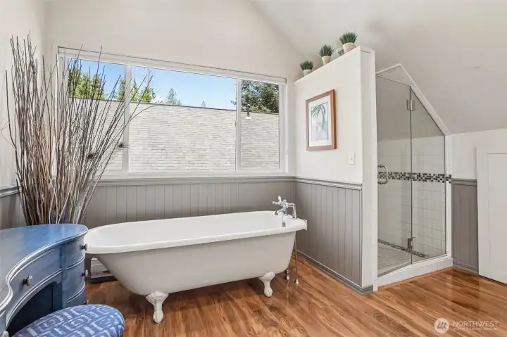 The spa-inspired primary bathroom features a freestanding soaking tub, walk-in shower, and abundant natural light for a relaxing retreat.
