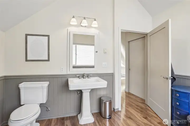 The updated primary bathroom features a modern vanity, contemporary finishes, and a bright, clean design.