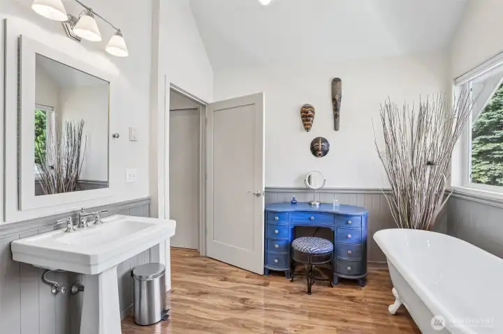 Unwind in the beautifully updated primary bathroom showcasing a freestanding soaking tub, contemporary fixtures, and a serene atmosphere.