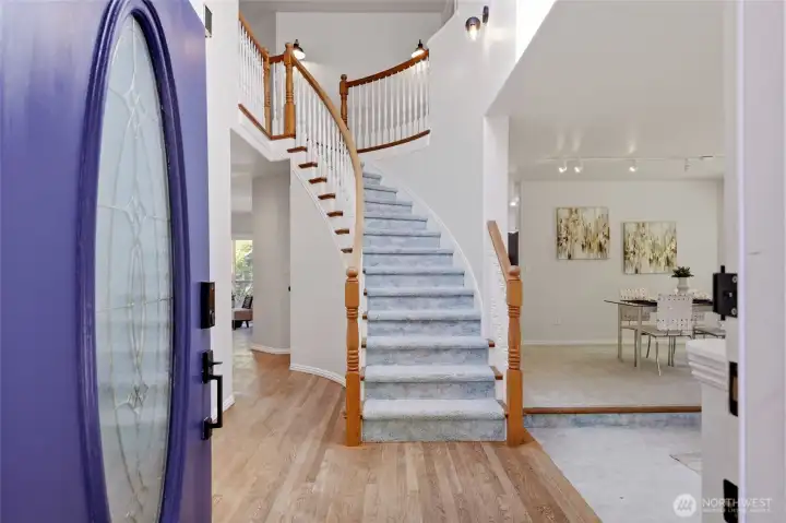 Lovely oval-glass front door and curved staircase set the tone for the interior details and charming elements of this spacious home.