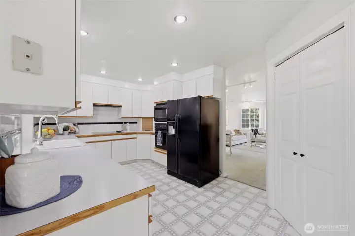 This spacious and bright kitchen is as functional as it is appealing--lots of storage, including the walk-in-pantry seen here.