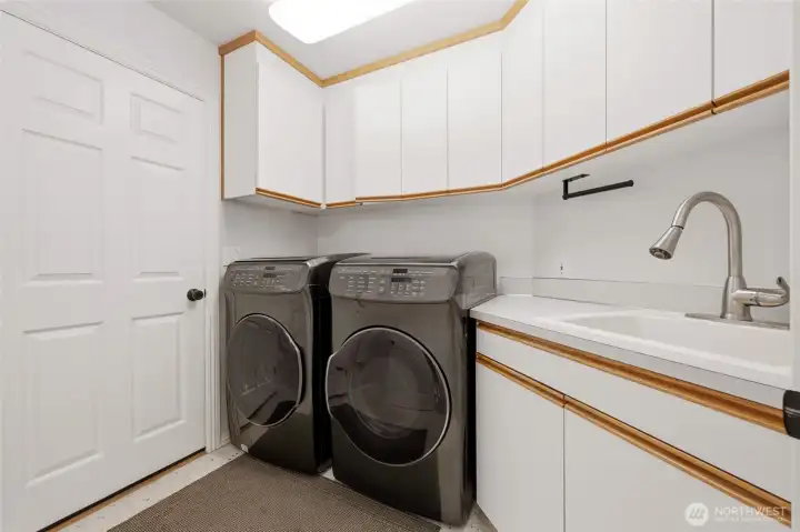 The main floor laundry room offers quite a bit of storage, large utility sink, and laundry chute from the bathroom above! :D  Washer and dryer are included.