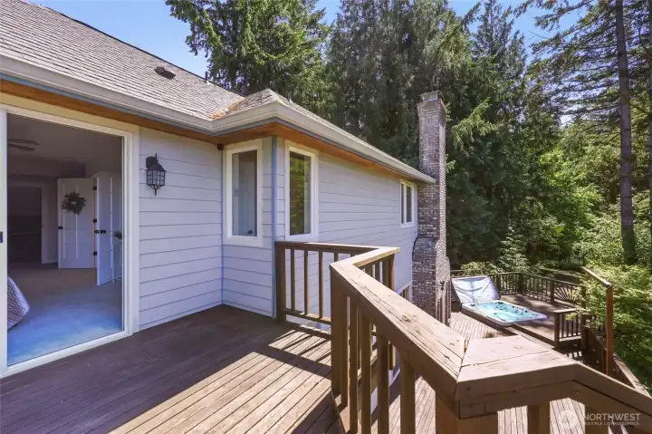 This primary en suite deck is perched above for privacy and the very best views... with easy access to the hot tub below!