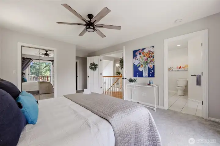 French doors, mirrored closet, extra storage closet, and spacious bathroom are all spotted in this photo.