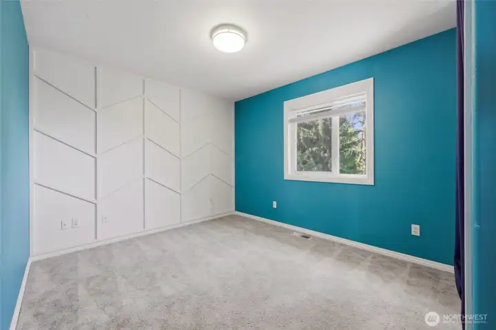 Bedroom #2 features a fabulous accent wall design for extra character and fun!