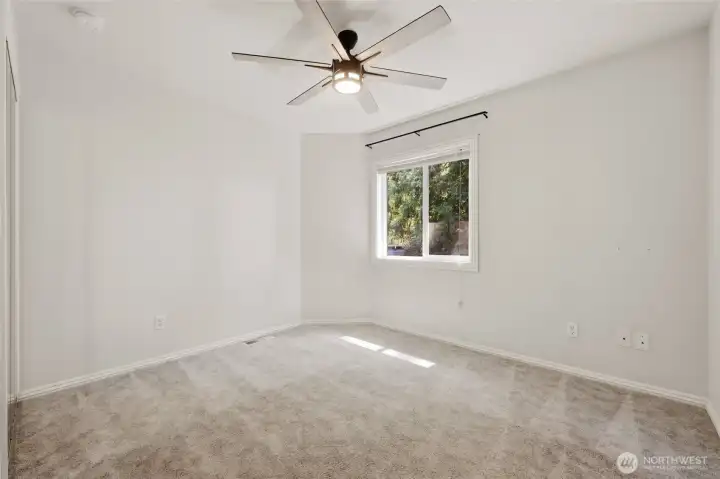Bedroom #3 with ceiling fan and mirrored closet doors.