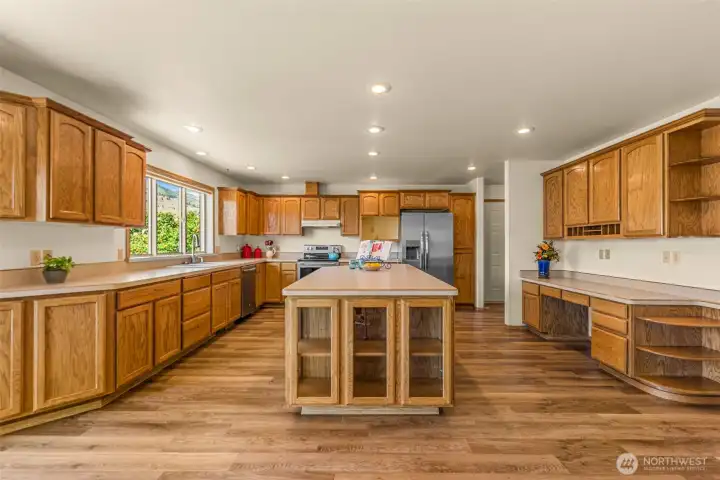 In the heart of the home, in this expansive kitchen. Designed with culinary enthusiasts in mind, it features an oversized center island that provides the perfect space to create your own culinary magic. With abundant cabinetry for storage and plenty of room to move, this kitchen flawlessly blends professional functionality with everyday comfort.
