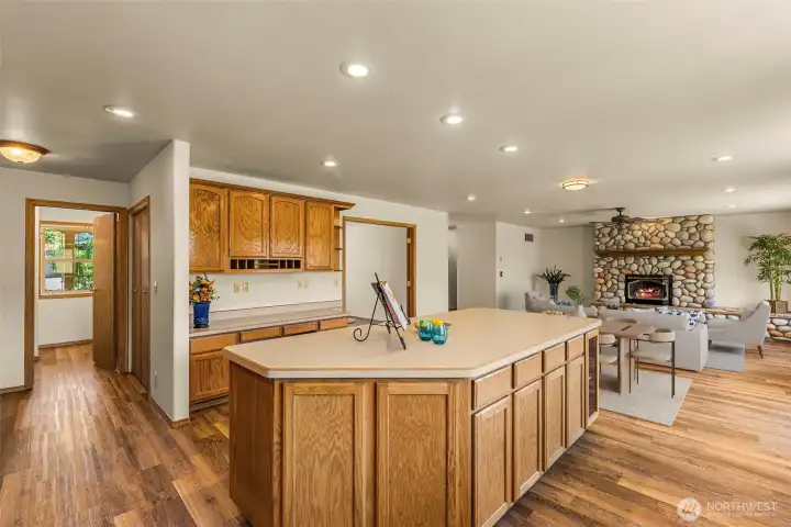 Keeping an eye on the living spaces while making dinner is an absolute breeze. It provides the perfect open-concept setting for a great evening of cooking and entertaining guests without ever feeling crammed. Plus, you will find a highly convenient laundry area located just inside the bathroom to the left. The photo was virtually staged.