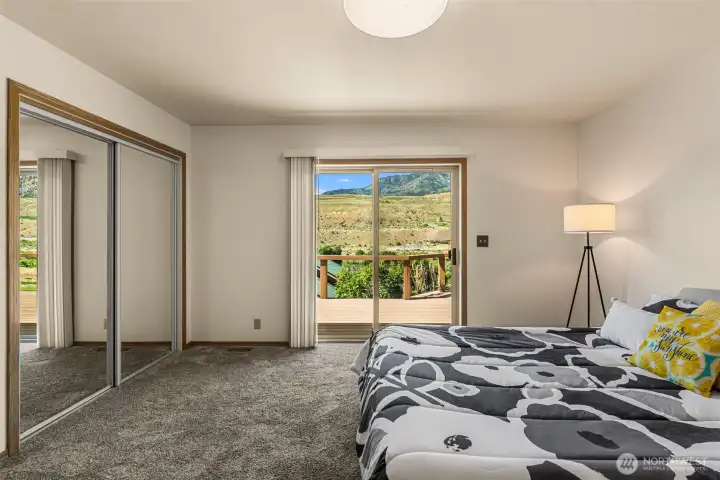 Wake up to beauty every morning in this stunning home. The primary bedroom boasts ever-changing, panoramic views and offers the incredible convenience of direct backyard access right from your room. It is the perfect, serene setting to help you feel refreshed and ready to start the day right.