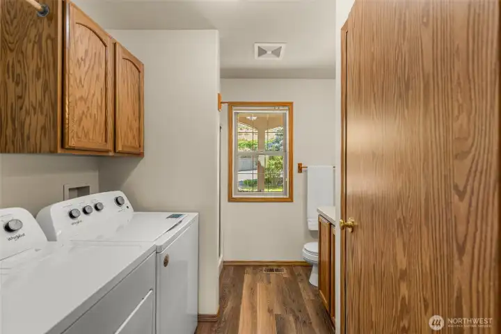 Located just off the kitchen, you will find a highly practical laundry room and an adjoining 3/4 bathroom. This space is perfectly situated to keep the hassle of daily chores at bay.