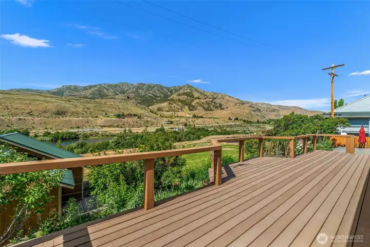 Step outside the primary bedroom onto this expansive deck offering unparalleled panoramic views. Looking southwest toward Billy Goat Mountain, this incredible outdoor living space provides the ultimate backdrop for entertaining, relaxing, and taking in the breathtaking Methow Valley scenery.