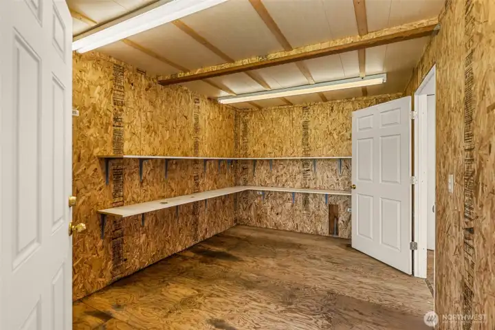 Step inside this versatile she shed! The entryway offers convenient storage and features a door leading to a separate second room. This flexible bonus space is the perfect functional addition.