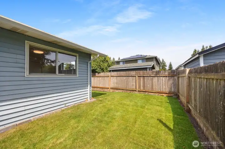 Grassy area along SE side of the home is the perfect green space between the east and south patios. Grassy area along SE side of the home is the perfect green space between the east and south patios.