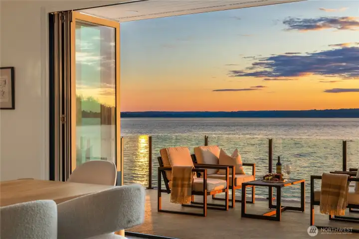 Folding walls of glass give an expansive open air experience.  Dive into the Puget Sound lifestyle from inside or outside of your dream home.