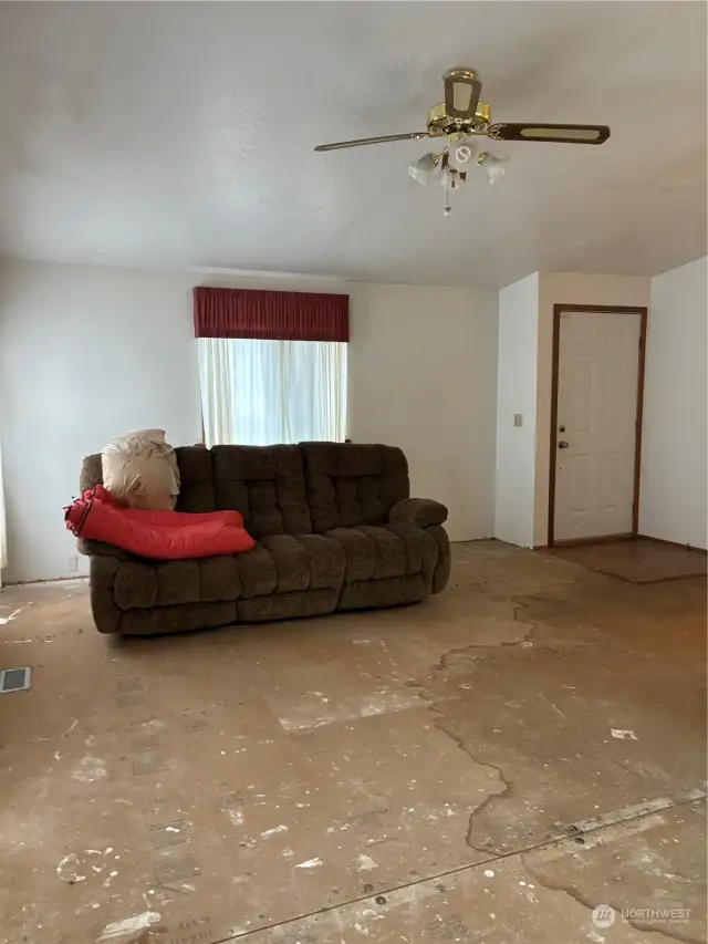 Livingroom. As you can see there was water damage from the wet carpet. The carpet has been removed, as previously stated, and the carpet needs to be replaced. There is some damage to the subfloors. The house is priced according to it's condition and is being sold as-is