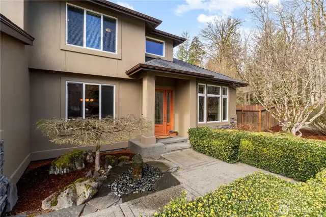 Front yard features a water fountain and mature landscaping.