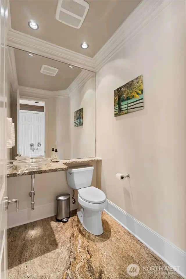 Guest Bathroom features granite slab floor and floating countertop