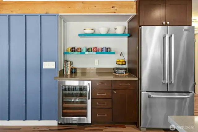 The coffee bar and beverage fridge in the kitchen.