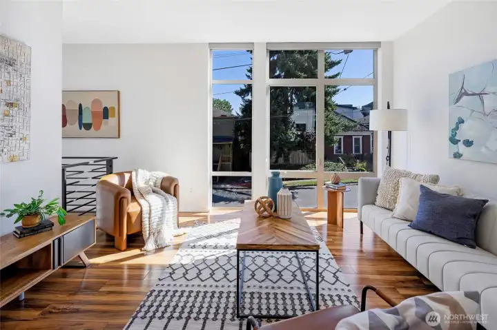 Sun-filled living room with south-facing floor-to-ceiling windows—ideal for movie nights or curling up with a book.