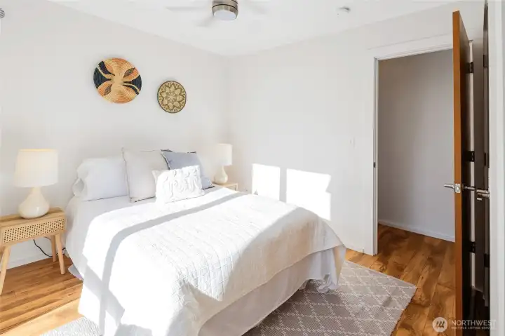 West-facing bedroom with a serene, modern feel and large windows—ideal for soaking up sunsets.