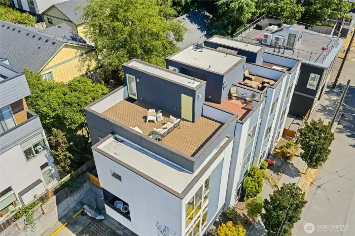 Aerial view of the private rooftop deck, showcasing its spacious layout and privacy compared to neighboring homes—your own urban oasis above it all.