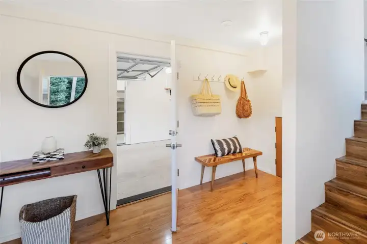 From the entryway, a peek into the attached 1-car garage. The entry offers space for coats, shoes, and everyday essentials—making comings and goings a breeze.