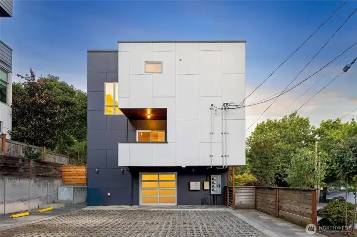 Rear exterior of the townhouse, highlighting its modern design and private garage entrance.