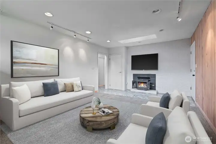 Cozy family room featuring a charming wood-burning fireplace insert-perfect for gatherings and relaxing. Warmth and comfort come together in this inviting space