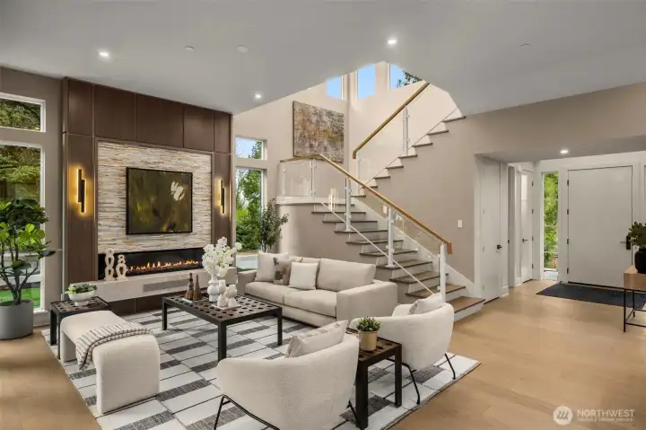 Elevated Great Room w/ Stone Statement Centerpiece, Soaring Ceilings, Linear Fireplace Glow, & Ambient Accent Lighting.