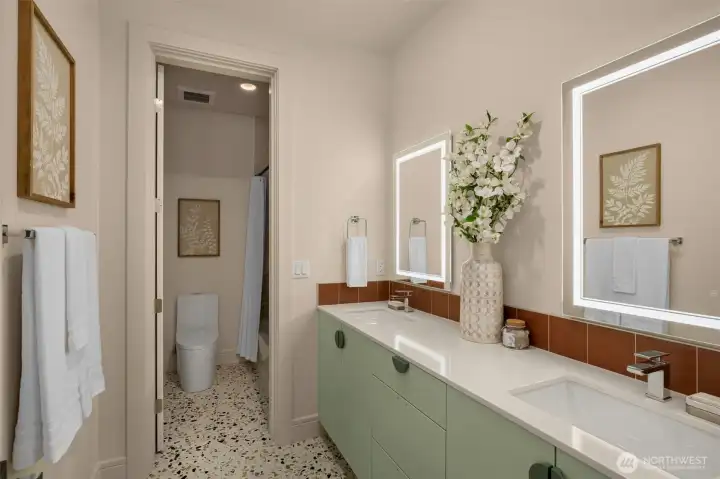 Chic Guest Bath w/ Smart Backlit Mirror, Mint-Fresh Color Palette & Artistic Tile Design.